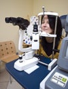 Woman sitting in optician machine Royalty Free Stock Photo