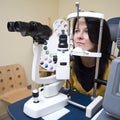 Woman sitting in optician machine