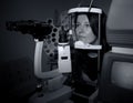 Woman sitting in optician machine Royalty Free Stock Photo