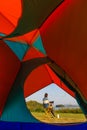 A woman sitting outside a camping tent and using laptop notebook computer working beside wide and big lake with clear blue sky and Royalty Free Stock Photo