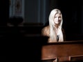 Woman sitting on a Pew