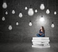 Woman sitting on a pile of books thinking about problem