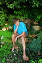 Woman sitting among the plants in the garden Royalty Free Stock Photo