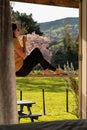 Woman sitting in the porch of a cabin on a farm during springtime Royalty Free Stock Photo