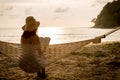 Woman sitting and reading in hammock. Royalty Free Stock Photo