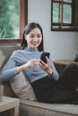 Woman is sitting and relaxing on the sofa, Sitting comfortably on the sofa, Relax in the living room at home on holiday, Live a Royalty Free Stock Photo