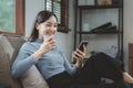 Woman is sitting and relaxing on the sofa, Sitting comfortably on the sofa, Relax in the living room at home on holiday, Live a Royalty Free Stock Photo