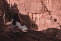 Woman sitting at the rock in Nabataean temple, Petra