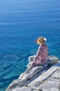 Woman sitting on the rock near the sea Royalty Free Stock Photo