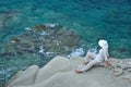 Woman sitting on the rock near the sea Royalty Free Stock Photo