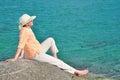 Woman sitting on the rock near the sea Royalty Free Stock Photo