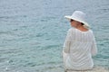 Woman sitting on the rock near the sea Royalty Free Stock Photo