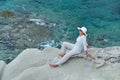 Woman sitting on the rock near the sea Royalty Free Stock Photo