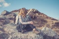 Woman sitting on rocks