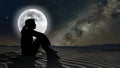 woman sitting on sand in the moonlight Royalty Free Stock Photo