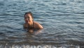 Woman sitting in in sea in Greece