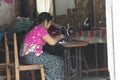 Woman sitting on a sewing machine