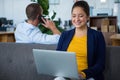 Woman sitting on sofa using laptop Royalty Free Stock Photo