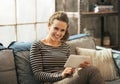 Woman sitting on sofa and using tablet pc in loft Royalty Free Stock Photo