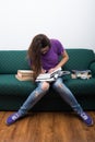 Woman sitting on sofa and writing in book Royalty Free Stock Photo
