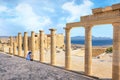 Woman sitting on Staircase of the Propylaea on the Acropolis of Lindos Rhodes, Greece