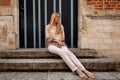 Woman sitting stairs medieval Romanesque door evening sun Royalty Free Stock Photo