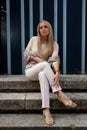 Woman sitting stairs medieval Romanesque door Royalty Free Stock Photo