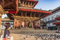 Woman sitting on the steps of a temple on Durbar square in Kathmandu