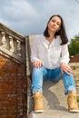 Woman sitting on stone staircase railing Royalty Free Stock Photo