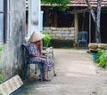 A woman sitting on street in Hoi An, Vietnam