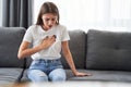 Woman sitting with strong chest pain Royalty Free Stock Photo