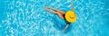 Woman sitting in a swimming pool on a ring pool float in a large yellow sunhat BANNER, LONG FORMAT Royalty Free Stock Photo