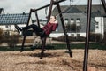 Woman sitting on a swing. Weekend concept