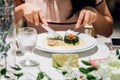 Woman sitting at table and having nice dinner