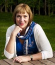 Woman sitting at a table outdoors