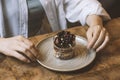 woman sitting at table with served chocolate dessert