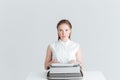 Woman sitting at the table and typing on retro machine Royalty Free Stock Photo