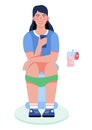 Woman sitting on the toilet and holding mobile phone