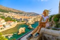 Woman sitting on top of Dubrovnik city of Croatia