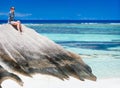 Woman sitting on top of granite rock