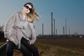 Woman sitting on used tire - Natural skin with no retouches