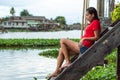 Woman sitting on wooden stairs water