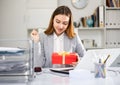 Woman sitting at work and receiving present Royalty Free Stock Photo