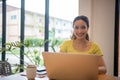 Woman sitting working with laptop at coffee shop, freelance woman working outside Concept Royalty Free Stock Photo