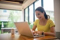 Woman sitting working with laptop at coffee shop, freelance woman working outside Concept Royalty Free Stock Photo