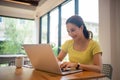 Woman sitting working with laptop at coffee shop, freelance woman working outside Concept Royalty Free Stock Photo