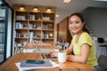 Woman sitting working with laptop at coffee shop, freelance woman working outside Concept Royalty Free Stock Photo