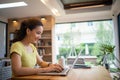 Woman sitting working with laptop at coffee shop, freelance woman working outside Concept Royalty Free Stock Photo