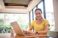 Woman sitting working with laptop at coffee shop, freelance woman working outside Concept Royalty Free Stock Photo