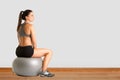 Woman Sitting on a Yoga Ball Royalty Free Stock Photo